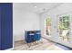 Eat-in kitchen has blue cabinets, a bar, and patio doors leading to deck at 5357 Beaver Br, Norcross, GA 30071