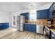 Kitchen boasts stainless steel appliances, blue cabinetry, and a modern backsplash, for a sleek and stylish space at 5357 Beaver Br, Norcross, GA 30071