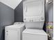 Efficient laundry room with a stackable washer and dryer unit and an additional washing machine at 5357 Beaver Br, Norcross, GA 30071