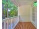 Charming back porch with white railing, wooden deck, and peaceful wooded view at 212 Warrenton Dr, Douglasville, GA 30134
