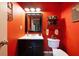 Half bathroom featuring a modern vanity, decorative shelves and vibrant colored walls at 212 Warrenton Dr, Douglasville, GA 30134