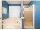Bathroom featuring a soaking tub and separate walk-in shower with a glass door at 212 Warrenton Dr, Douglasville, GA 30134