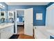 Bright bathroom featuring modern fixtures and a soaking tub next to the door at 212 Warrenton Dr, Douglasville, GA 30134