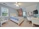 Comfortable bedroom with white walls, a bed, and a desk at 212 Warrenton Dr, Douglasville, GA 30134