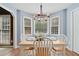 Charming dining area features wood-style floors, bay window, and elegant chandelier at 212 Warrenton Dr, Douglasville, GA 30134