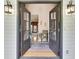 Inviting foyer with hardwood floors, vintage decor, and a view into the adjacent rooms at 212 Warrenton Dr, Douglasville, GA 30134