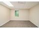 Finished basement featuring neutral carpet, a window, and a smooth, painted wall at 2120 Glenwood Downs Dr, Decatur, GA 30035