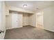Finished basement featuring carpet, neutral walls, and access to another room at 2120 Glenwood Downs Dr, Decatur, GA 30035