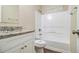 Bathroom with a granite-topped vanity and a shower-tub, ready for a refresh at 2120 Glenwood Downs Dr, Decatur, GA 30035