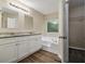 Bathroom featuring a dual sink vanity, soaking tub, and modern fixtures at 2120 Glenwood Downs Dr, Decatur, GA 30035