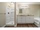 Bathroom with white cabinets, granite countertops, and a shower-tub combo at 2120 Glenwood Downs Dr, Decatur, GA 30035