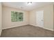 Clean bedroom with neutral carpet, a large window, and fresh paint at 2120 Glenwood Downs Dr, Decatur, GA 30035