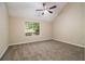 Bright bedroom featuring vaulted ceilings, ceiling fan, plush carpet and a large window offering natural light at 2120 Glenwood Downs Dr, Decatur, GA 30035