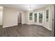 Dining area featuring hardwood floors, neutral walls, and glass doors leading to outdoor deck at 2120 Glenwood Downs Dr, Decatur, GA 30035