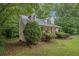 Attractive home with a well-kept lawn, a covered front porch, and lush, mature landscaping at 2120 Glenwood Downs Dr, Decatur, GA 30035