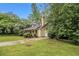 Charming home with a well-manicured lawn, mature landscaping, and a private driveway at 2120 Glenwood Downs Dr, Decatur, GA 30035