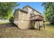 Multi-story home showcasing a wooden deck with an outdoor living space and a well kept lawn at 2120 Glenwood Downs Dr, Decatur, GA 30035