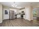 Well-lit kitchen featuring stainless steel appliances, granite countertops, modern cabinetry, and hardwood floors at 2120 Glenwood Downs Dr, Decatur, GA 30035