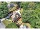 An aerial view shows this home with beautiful landscaping, a long driveway, and nestled among mature trees at 5121 Hunters Hill Sw Cv, Lilburn, GA 30047