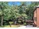 Relaxing backyard featuring a deck, patio, playground, and mature trees offering plenty of shade at 5121 Hunters Hill Sw Cv, Lilburn, GA 30047
