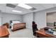 Finished basement featuring neutral carpet, a bed, desk and gaming chair at 5121 Hunters Hill Sw Cv, Lilburn, GA 30047