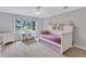 Bedroom showcasing a twin bed with built-ins, desk, dresser and window at 5121 Hunters Hill Sw Cv, Lilburn, GA 30047