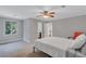 Bedroom featuring a window, fan, and doorway to an adjacent room at 5121 Hunters Hill Sw Cv, Lilburn, GA 30047