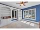 Cozy bedroom with built-in shelving, neutral carpet, and bright blue walls at 5121 Hunters Hill Sw Cv, Lilburn, GA 30047