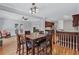 Charming dining area featuring hardwood floors, modern chandelier and views of the kitchen at 5121 Hunters Hill Sw Cv, Lilburn, GA 30047