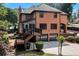 Exterior back elevation features a screened porch, deck, and two car garage at 5121 Hunters Hill Sw Cv, Lilburn, GA 30047
