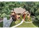 Stunning two-story brick home featuring a well-manicured lawn, mature trees, and a circular driveway at 5121 Hunters Hill Sw Cv, Lilburn, GA 30047