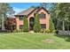 Beautiful brick home with a meticulously maintained front lawn and landscaping and dark trim at 5121 Hunters Hill Sw Cv, Lilburn, GA 30047