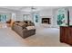 Bright and airy living room with a fireplace, large windows, and neutral-colored walls at 5121 Hunters Hill Sw Cv, Lilburn, GA 30047