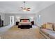 Spacious main bedroom features a sitting area, carpet and double door entryway at 5121 Hunters Hill Sw Cv, Lilburn, GA 30047