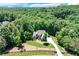 Secluded home nestled among a dense forest with a long private driveway and lush landscaping at 8240 Hurakan Creek Xing, Cumming, GA 30028