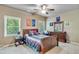Cozy bedroom with neutral carpet, plenty of natural light, and ceiling fan at 8240 Hurakan Creek Xing, Cumming, GA 30028