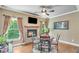 Cozy breakfast nook with a stone fireplace, natural light, and a view of the outdoors at 8240 Hurakan Creek Xing, Cumming, GA 30028