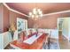 Formal dining room featuring hardwood floors and an elegant chandelier at 8240 Hurakan Creek Xing, Cumming, GA 30028