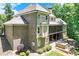 View of a two-story brick home with a screened porch and an outdoor cooking area in the backyard at 8240 Hurakan Creek Xing, Cumming, GA 30028