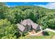 Beautiful home surrounded by mature trees and lush greenery, offering privacy and a serene setting at 8240 Hurakan Creek Xing, Cumming, GA 30028
