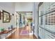 Welcoming foyer with hardwood floors, elegant lighting, and a view into the living space at 8240 Hurakan Creek Xing, Cumming, GA 30028