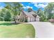 Charming home with a three-car garage, well-maintained lawn, and beautiful landscaping at 8240 Hurakan Creek Xing, Cumming, GA 30028