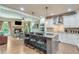 Modern kitchen with white cabinets, stainless steel appliances, granite countertops, and an island with seating at 8240 Hurakan Creek Xing, Cumming, GA 30028