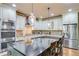 Gourmet kitchen featuring stainless steel appliances, granite countertops, an island, and pendant lighting at 8240 Hurakan Creek Xing, Cumming, GA 30028