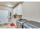 Modern laundry room with granite countertops and stainless steel washer and dryer at 8240 Hurakan Creek Xing, Cumming, GA 30028