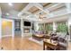 Inviting living room with coffered ceilings, hardwood floors, a stone fireplace, and built-in shelving at 8240 Hurakan Creek Xing, Cumming, GA 30028