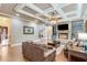 Comfortable living room featuring a fireplace, hardwood flooring, and coffered ceilings at 8240 Hurakan Creek Xing, Cumming, GA 30028