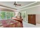 Spacious main bedroom with a tray ceiling, a fan, and lots of natural light at 8240 Hurakan Creek Xing, Cumming, GA 30028