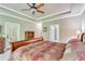 Bright main bedroom featuring a tray ceiling and access to the outside at 8240 Hurakan Creek Xing, Cumming, GA 30028