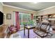 Home office with a large window, built-in bookshelves, and lots of natural light at 8240 Hurakan Creek Xing, Cumming, GA 30028